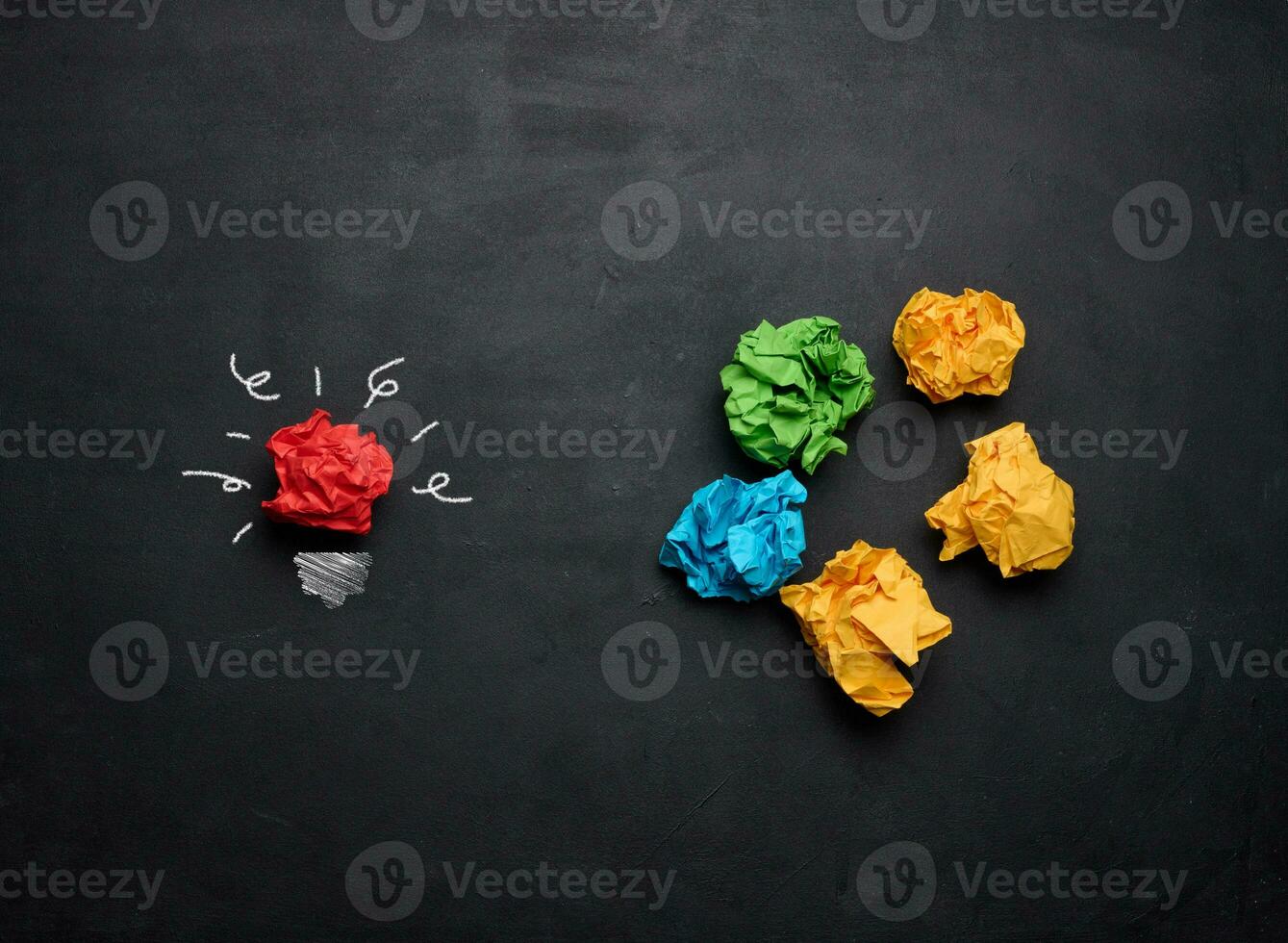 The concept of inspiration with new ideas, the search for creative solutions, crumpled sheets of paper in the form of balls on a black background photo