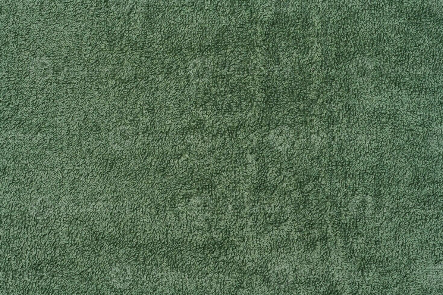 Texture of a green terry cotton towel, canvas. Macro photo