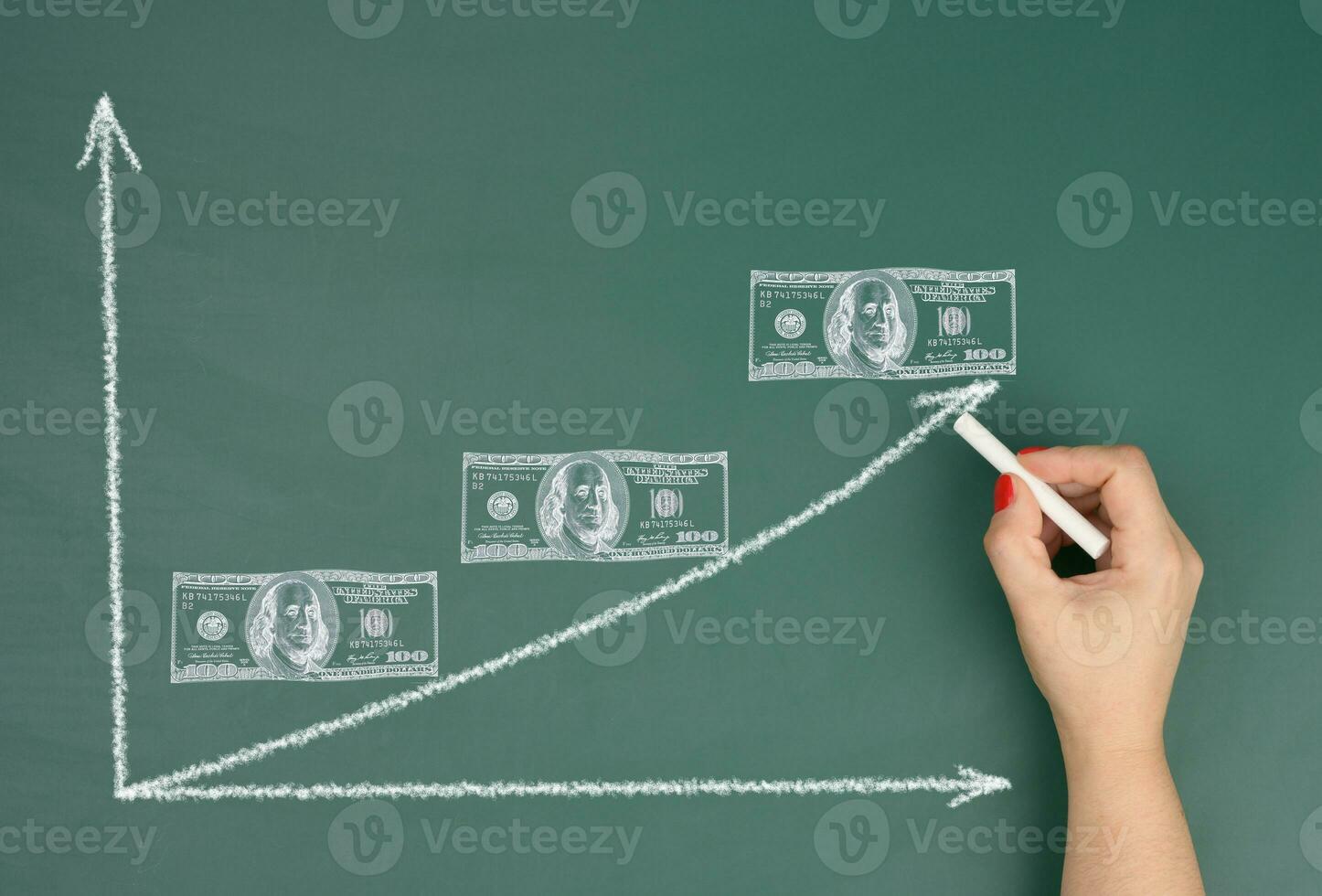 Female hand drawing an upward arrow on a graph and drawn dollars, concept of inflation growth, high profit photo