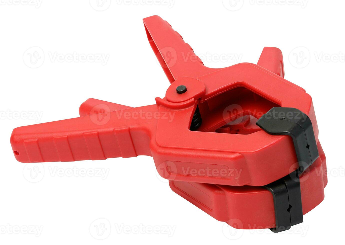 Large red plastic clamp on a white isolated background photo