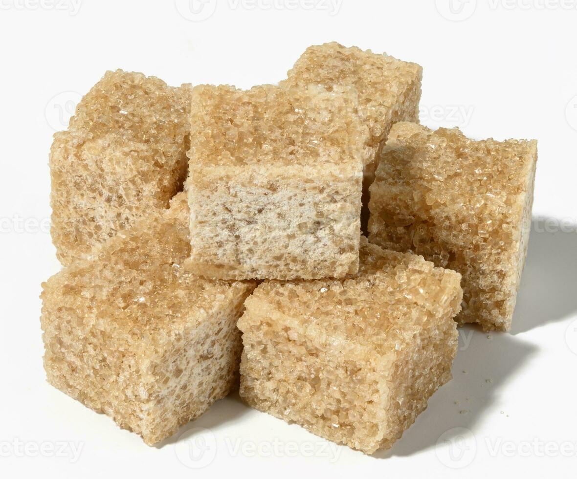 Cane sugar cubes on white background photo