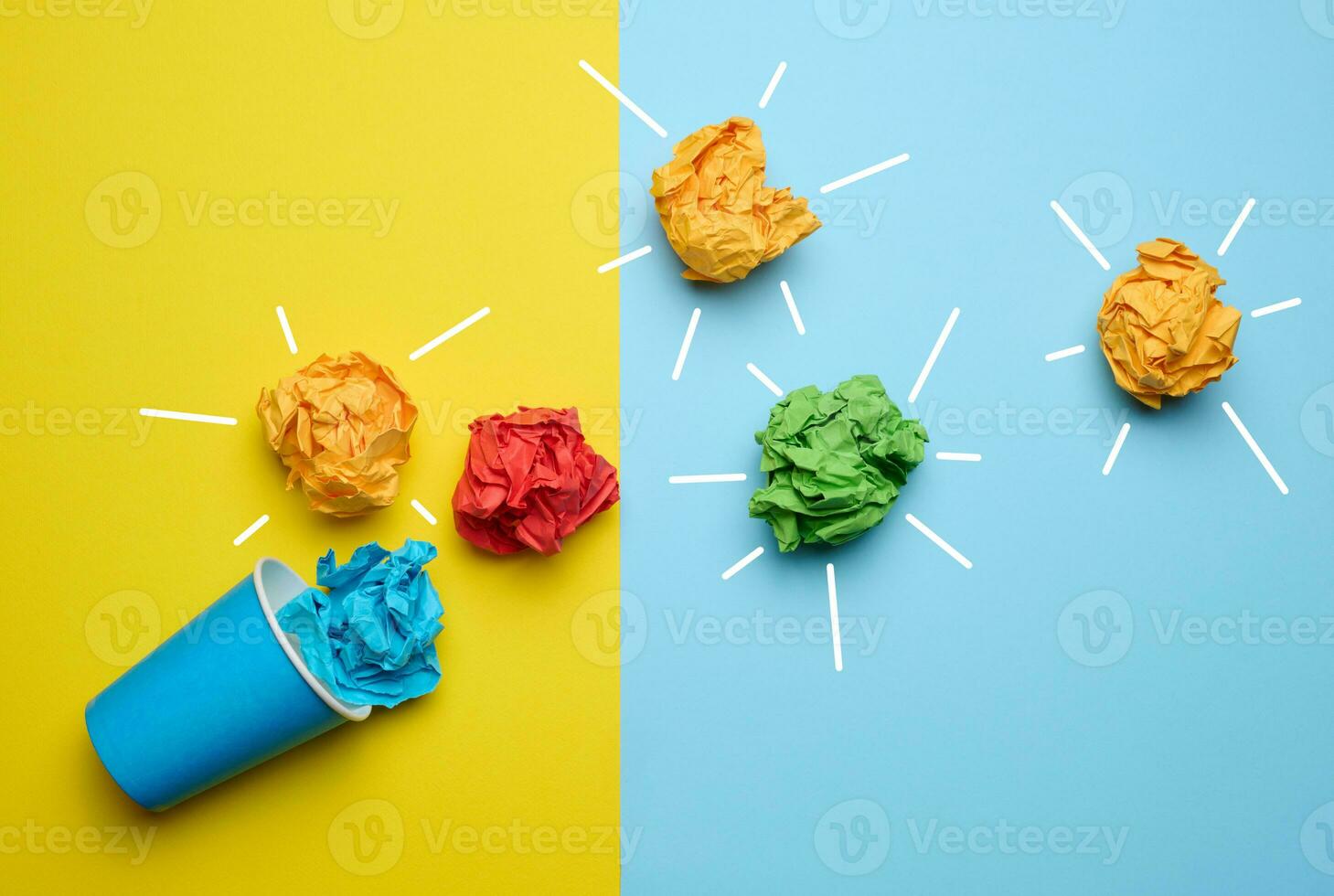 The concept of inspiration with new ideas, the search for creative solutions, crumpled sheets of paper in the form of balls on a blue yellow background photo