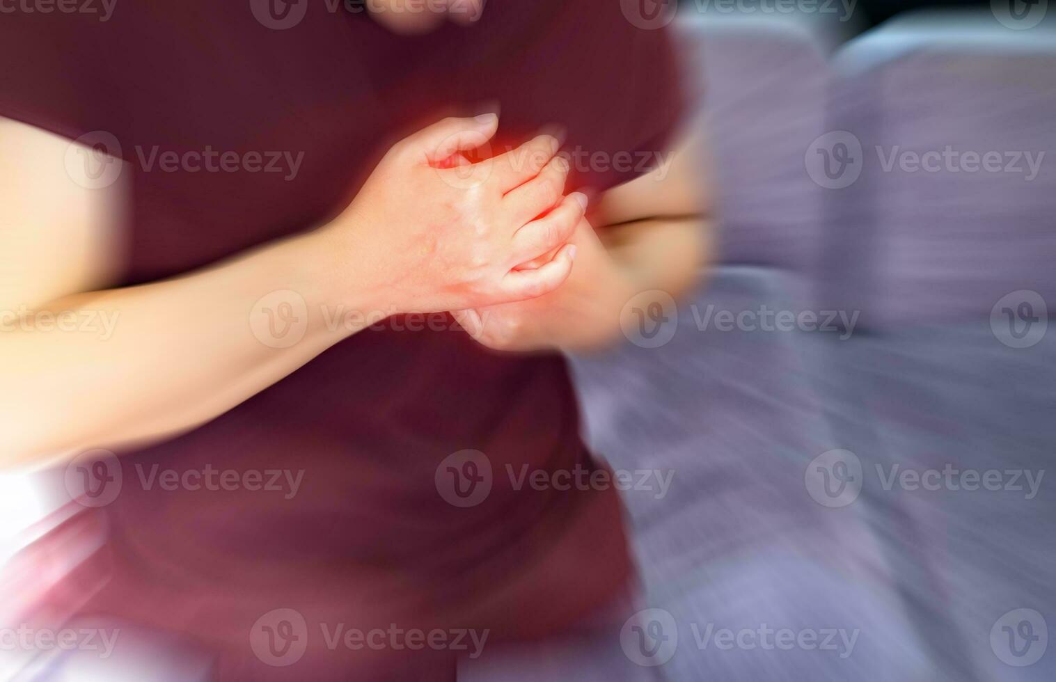 Severe heartache, women suffering from chest pain, having heart attack or painful cramps, hand holding pressing on chest with painful expression, Internal health care concept. photo