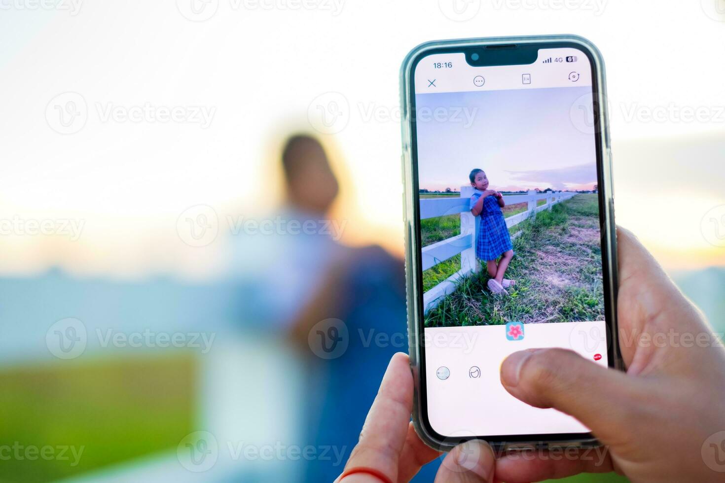 Mom is using her phone to take pictures of her daughter while on vacation. copy space photo