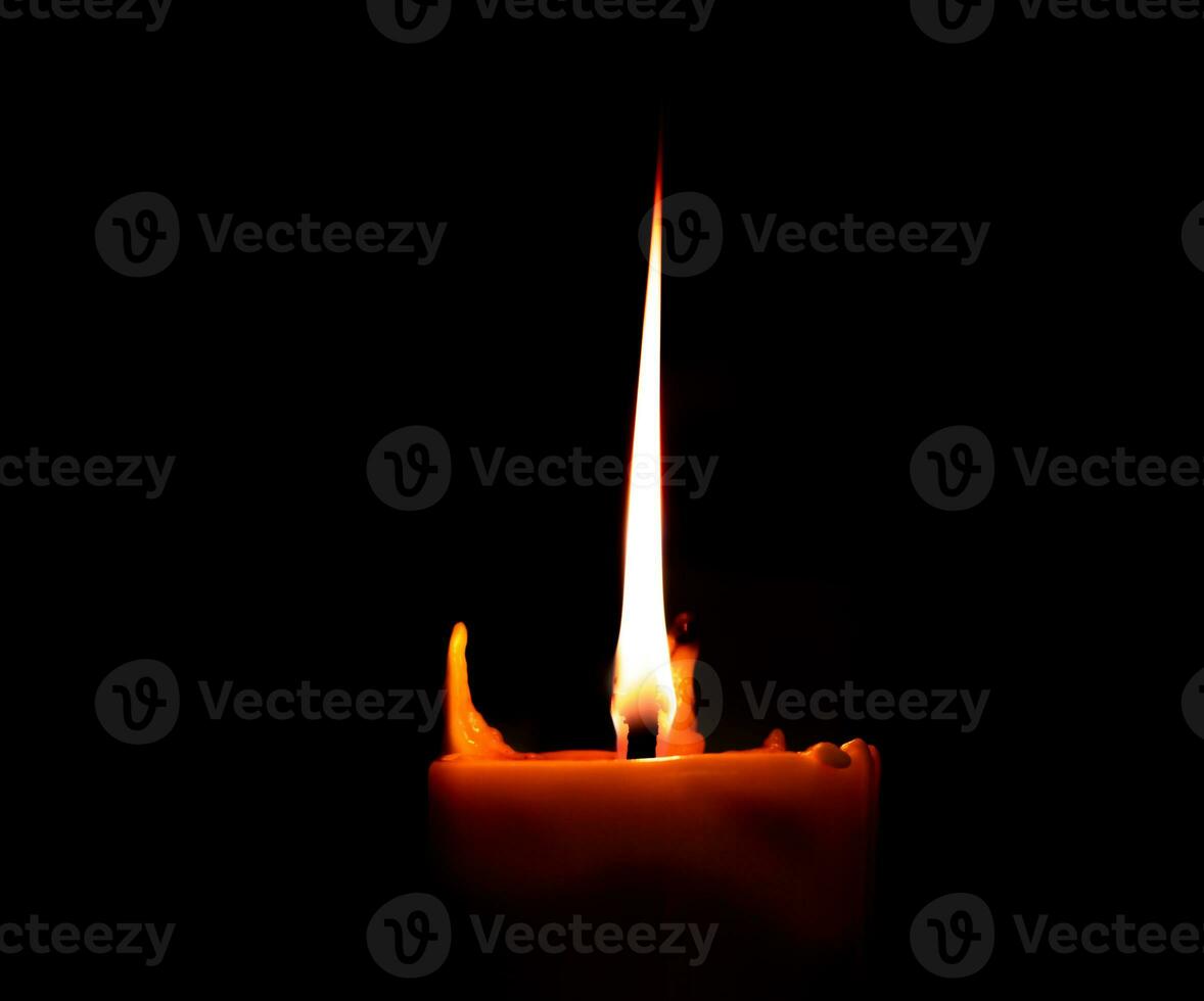 Burning big candle on dark candle holder and black background, space for text on top. Buddhism Memory day photo