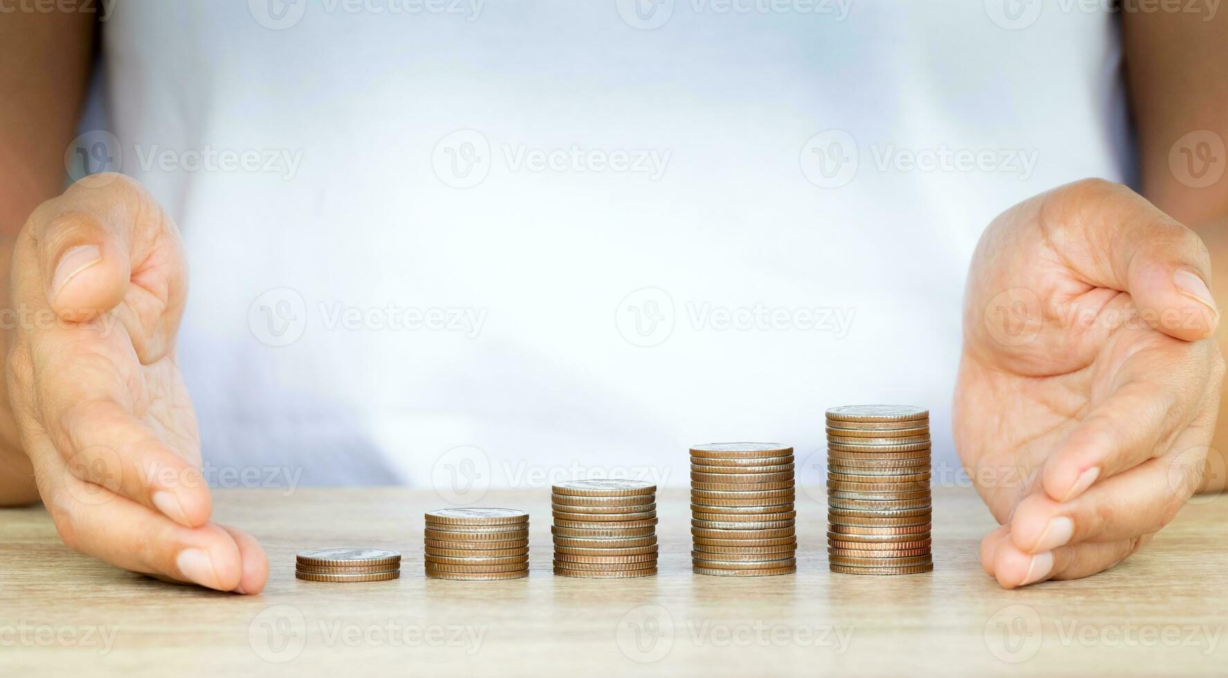 Saving money concept preset by female hand protection money coin stack growing busines,Saving money for future plan and saving ideas and money saving. photo