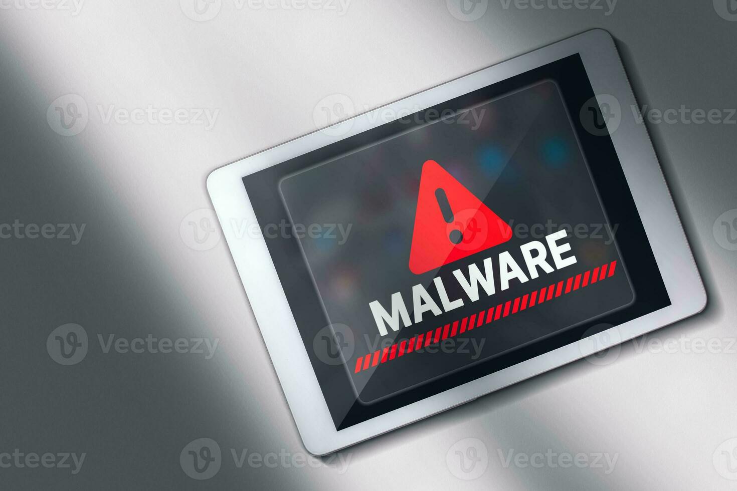 Desktop view photo of malware alert on digital tablet screen. Compromised information concept. Internet virus cyber security and cybercrime.