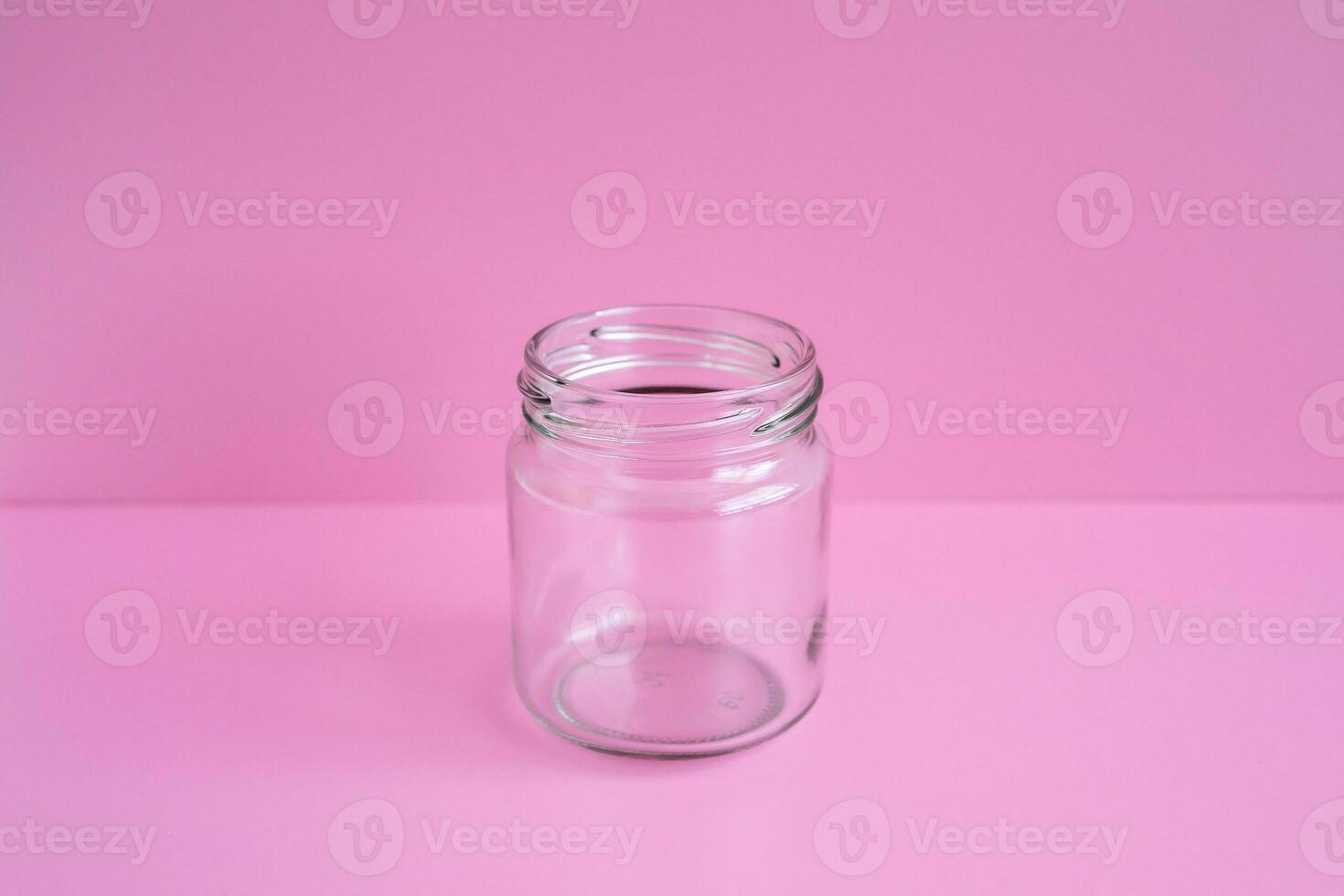 1 empty jar, no lid, with a pink scene, close up. photo