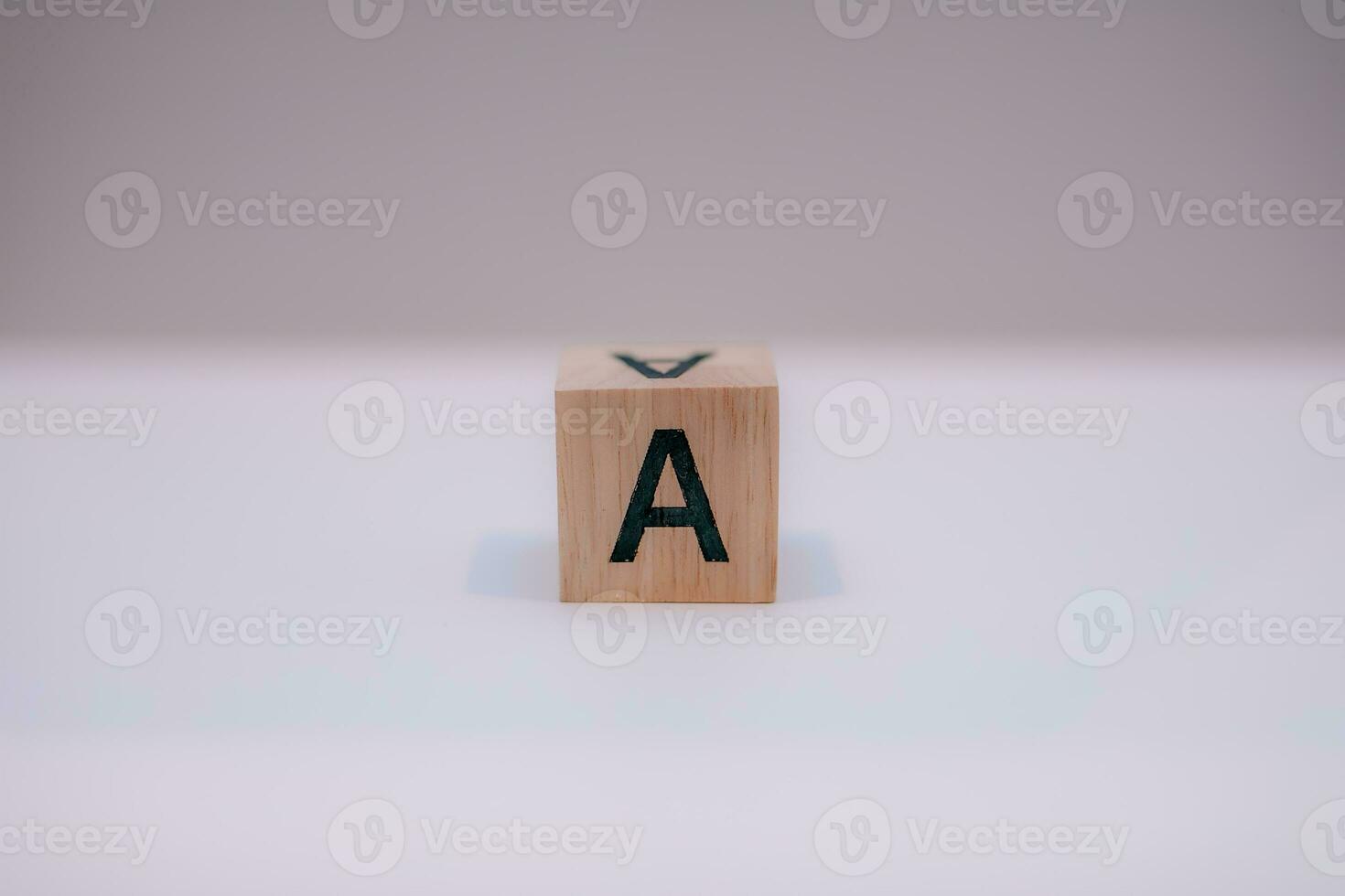 Wooden block written A with a white background, education concept, close up. photo