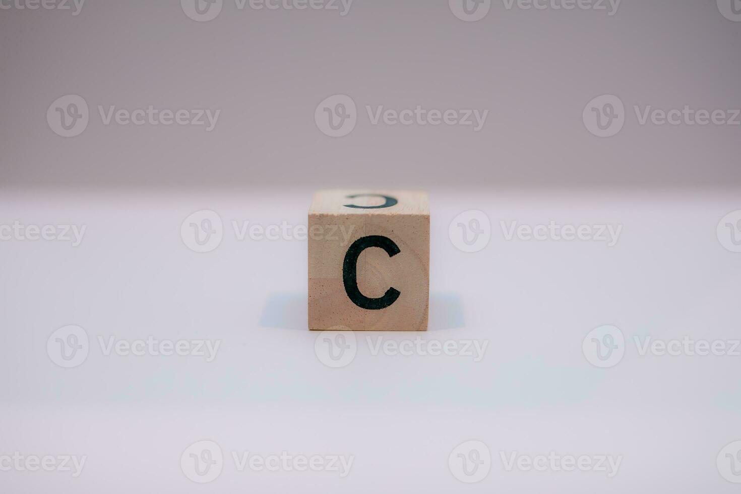 Wooden block written C with a white background, education concept, close up. photo