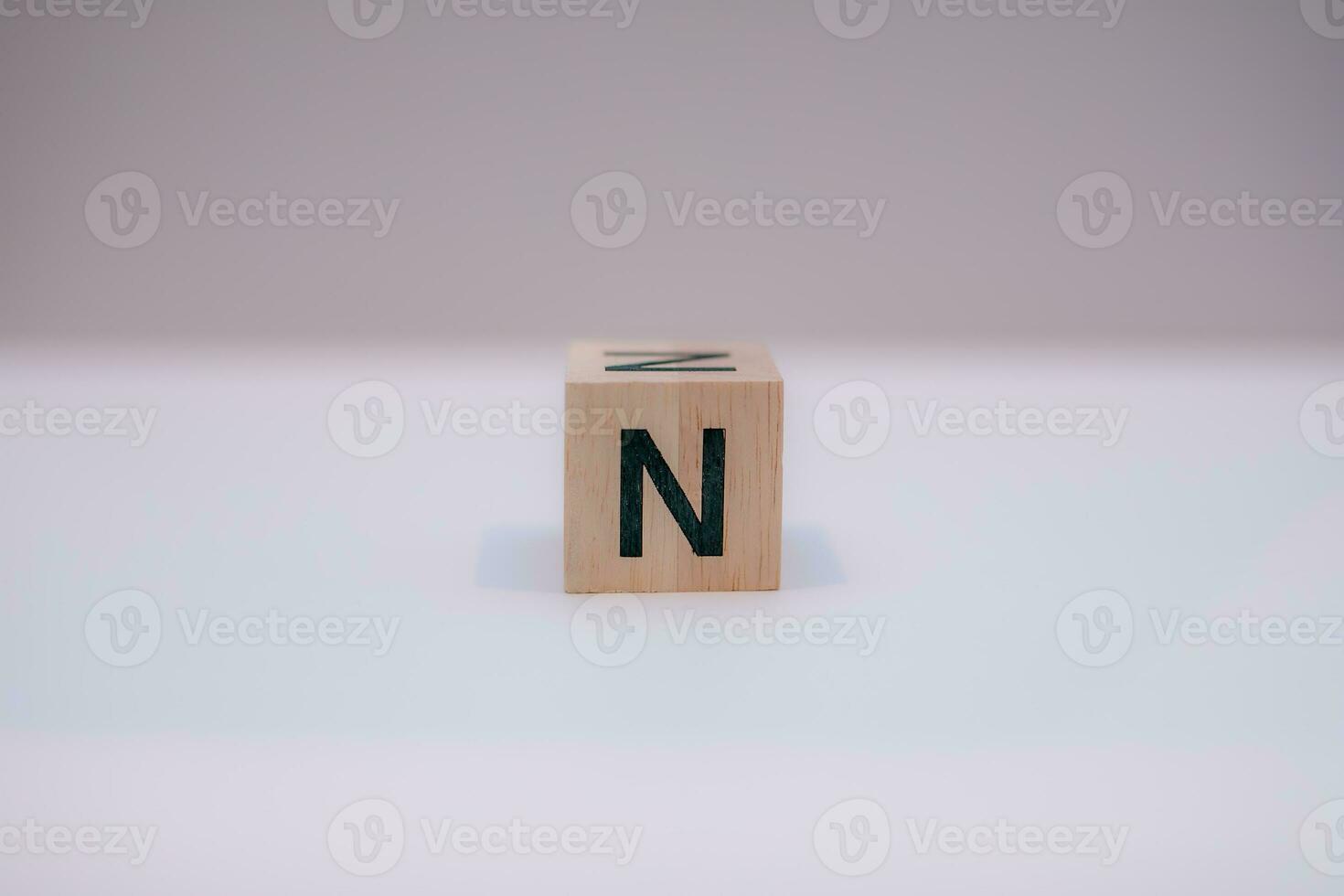 Wooden block written N with a white background, education concept, close up. photo