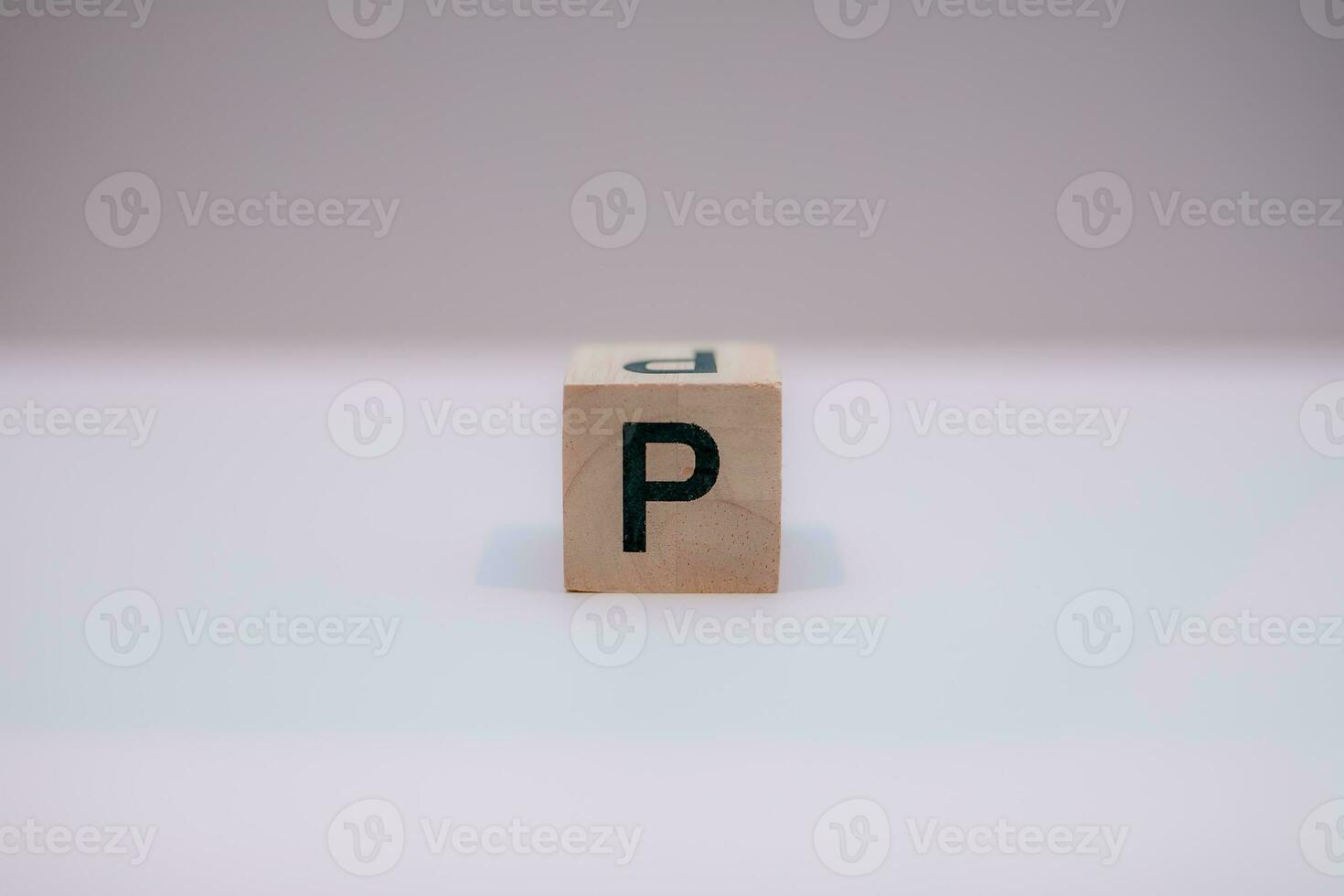 Wooden block written P with a white background, education concept, close up. photo