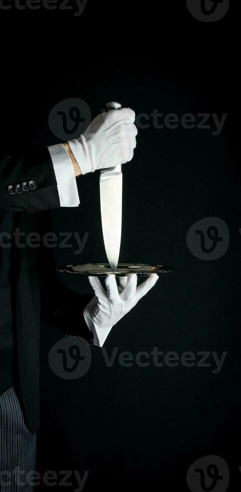 Isolated Close Up of Sharp Knife being Served on Silver Tray. Concept of Butler Did It Classic Murder Mystery photo