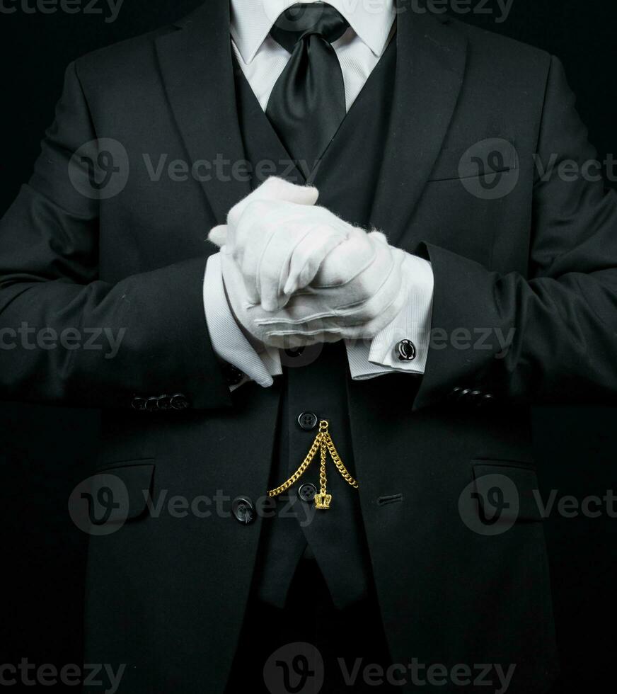 Portrait of Butler in Dark Suit and White Gloves Eager to be of Service. photo