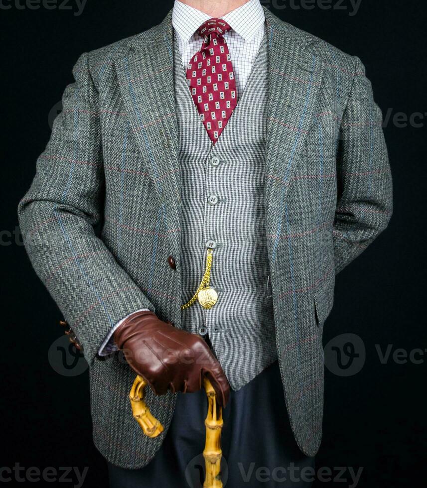 Portrait of Man in Tweed Suit and Leather Gloves Holding Umbrella. Vintage Style and Retro Fashion of Classic English Gentleman. photo