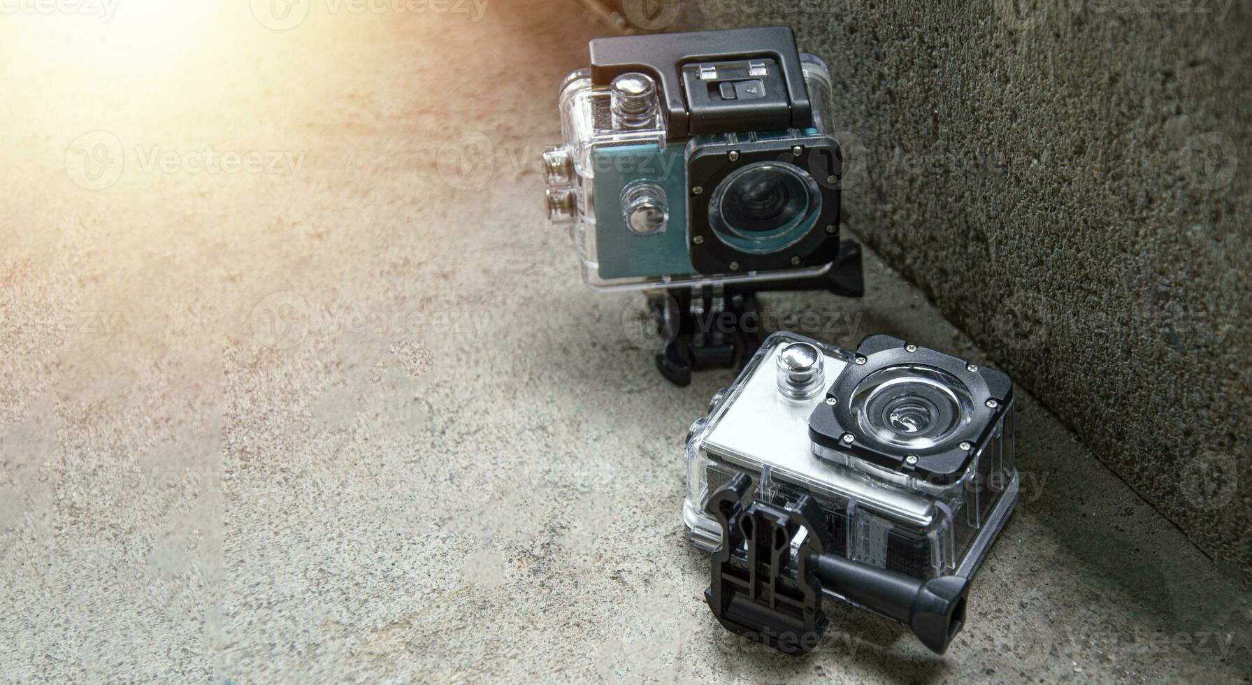 2 action cams placed on the floor, waterproof and dustproof photo