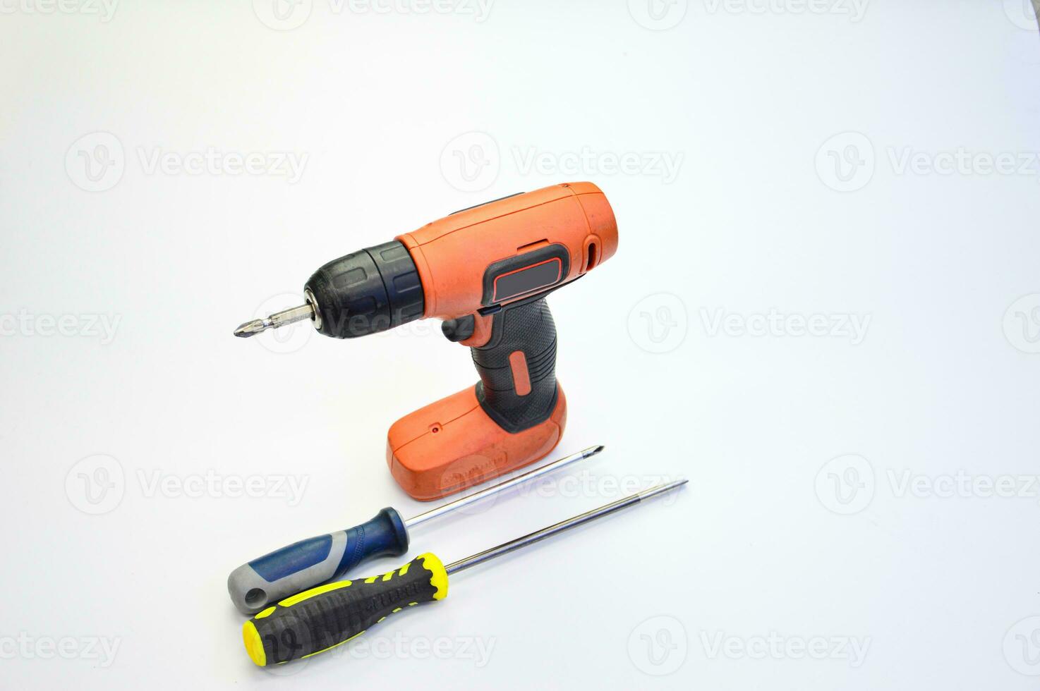 Electric screwdriver and hand screwdriver set on white background photo
