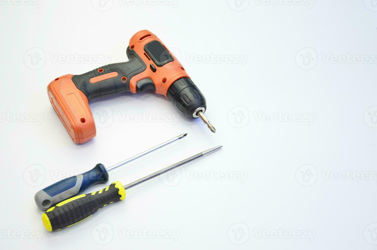 Electric screwdriver and hand screwdriver set on white background photo