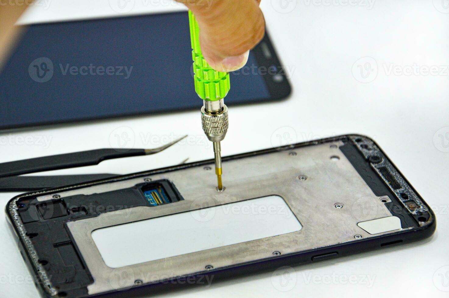 Smartphone repair technician checking symptoms photo