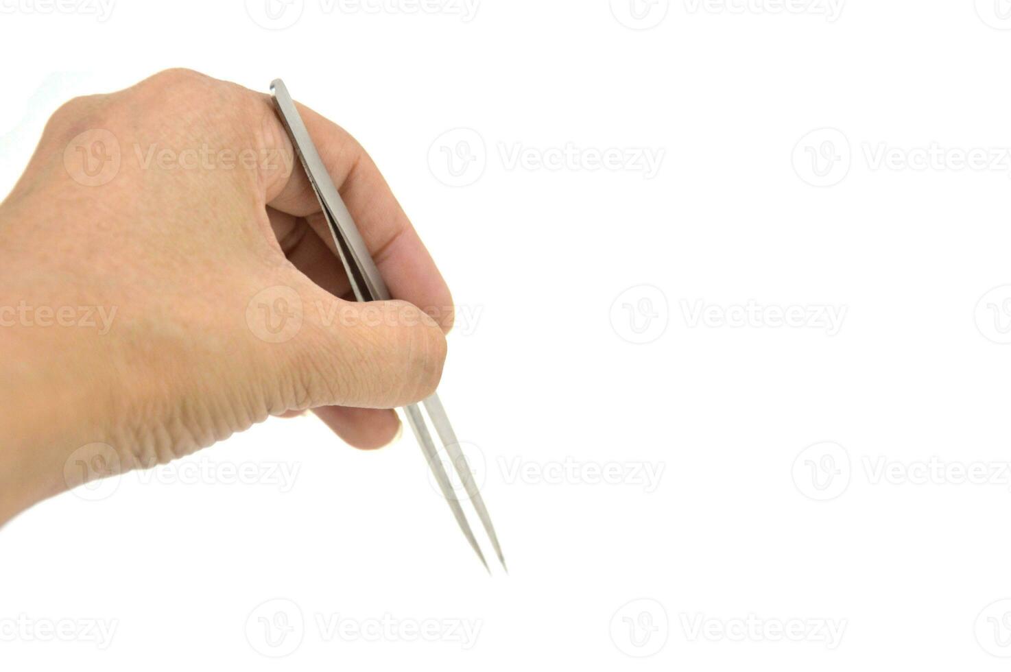 hands using tweezers on a white background photo