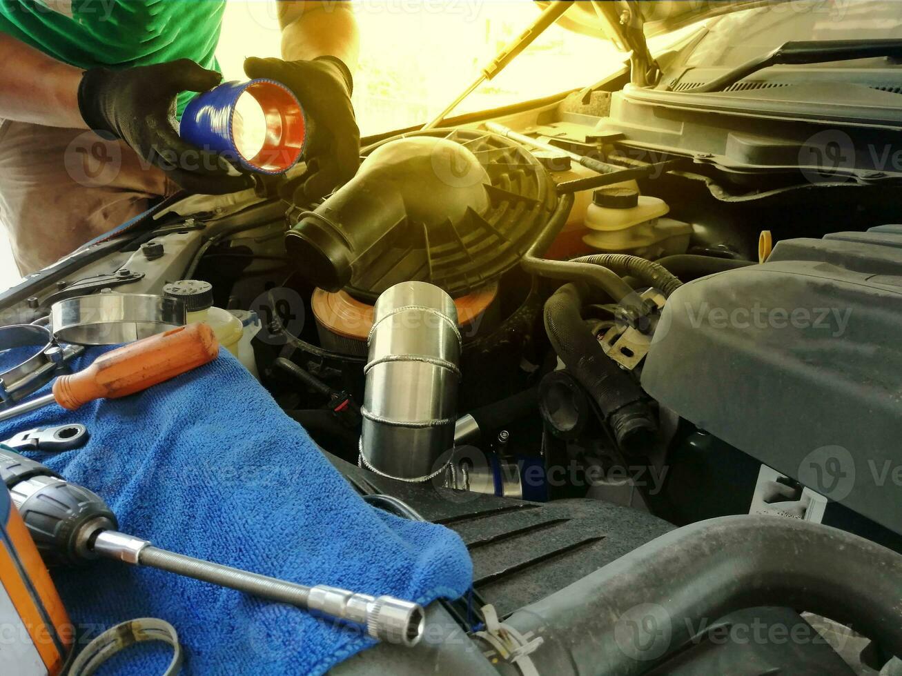 Technician repairing the engine, checking the engine oil change photo