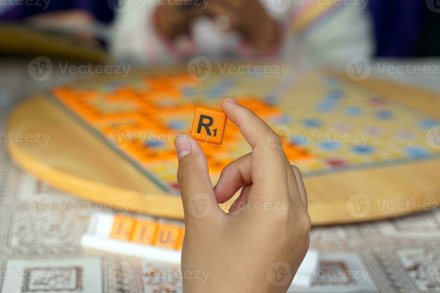 Asian high school students are competing in a Crossword or Scrabble game, an English word puzzle game. It is a game that promotes English learning and critical thinking skills. photo