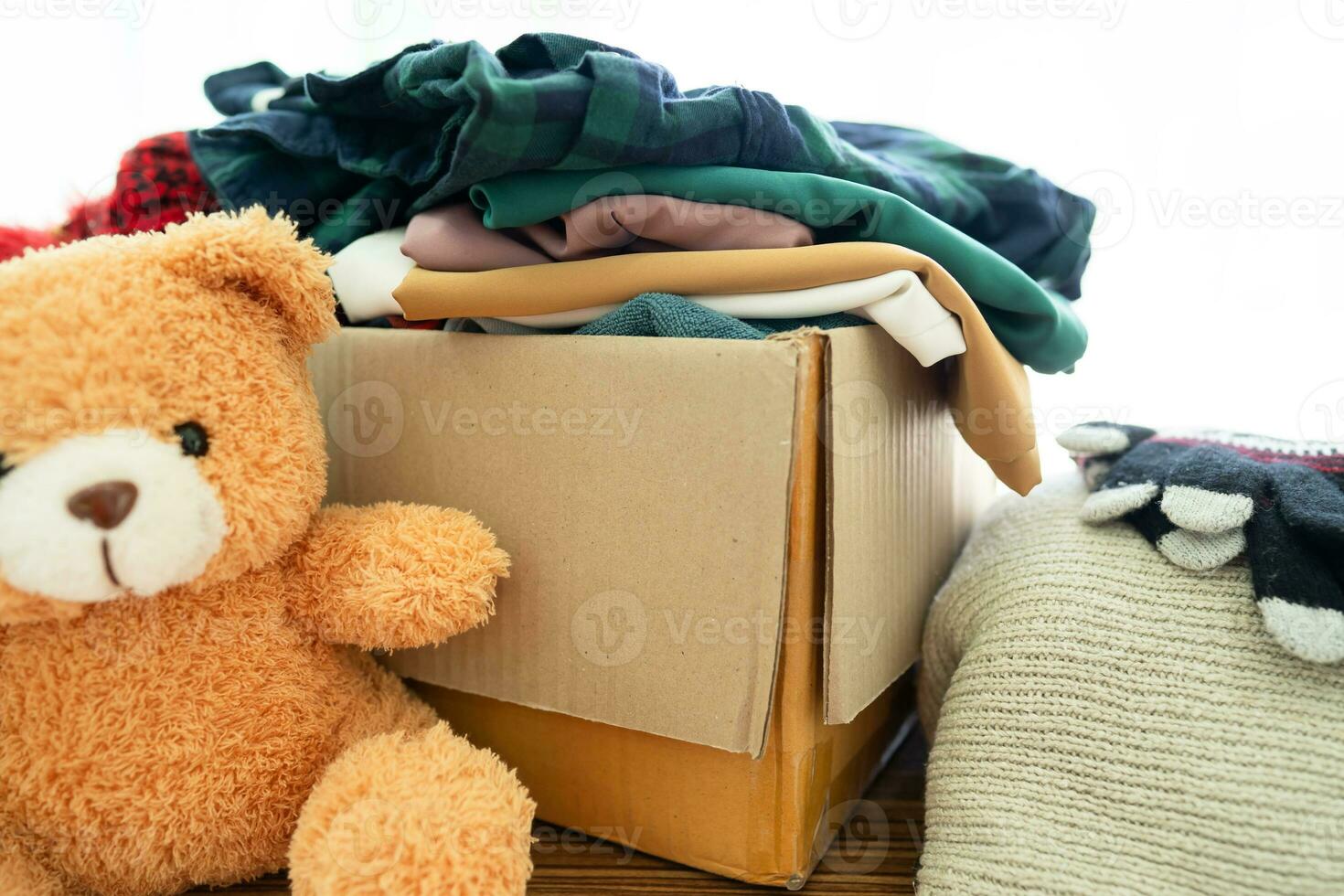 Donation box with used clothes at home to support help for poor people in the world. photo