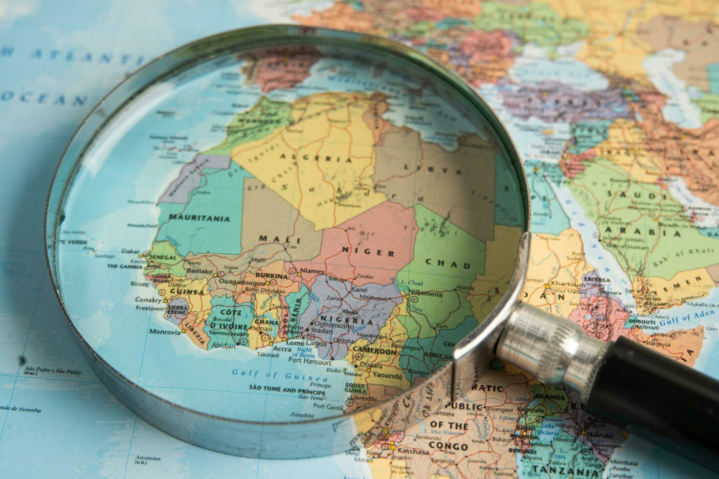 Bangkok, Thailand  January 20, 2022 Africa, Magnifying glass close up with colorful world map, travel, geography, tourism and exploration concept. photo