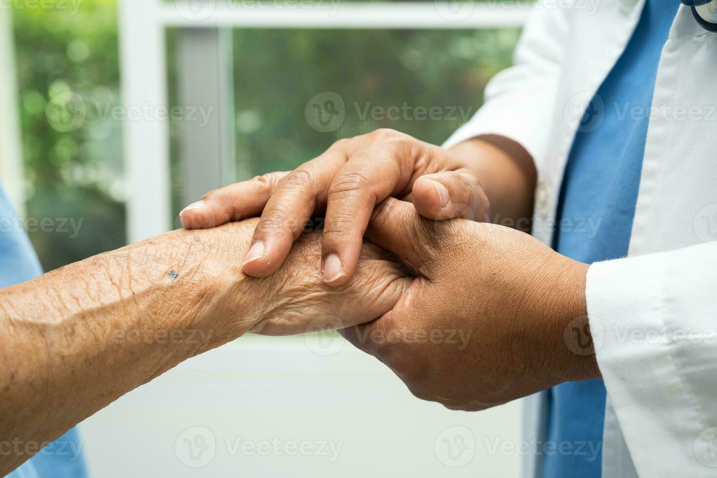 Caregiver holding hands Asian elderly woman patient with love, care, encourage and empathy at nursing hospital, healthy strong medical concept. photo