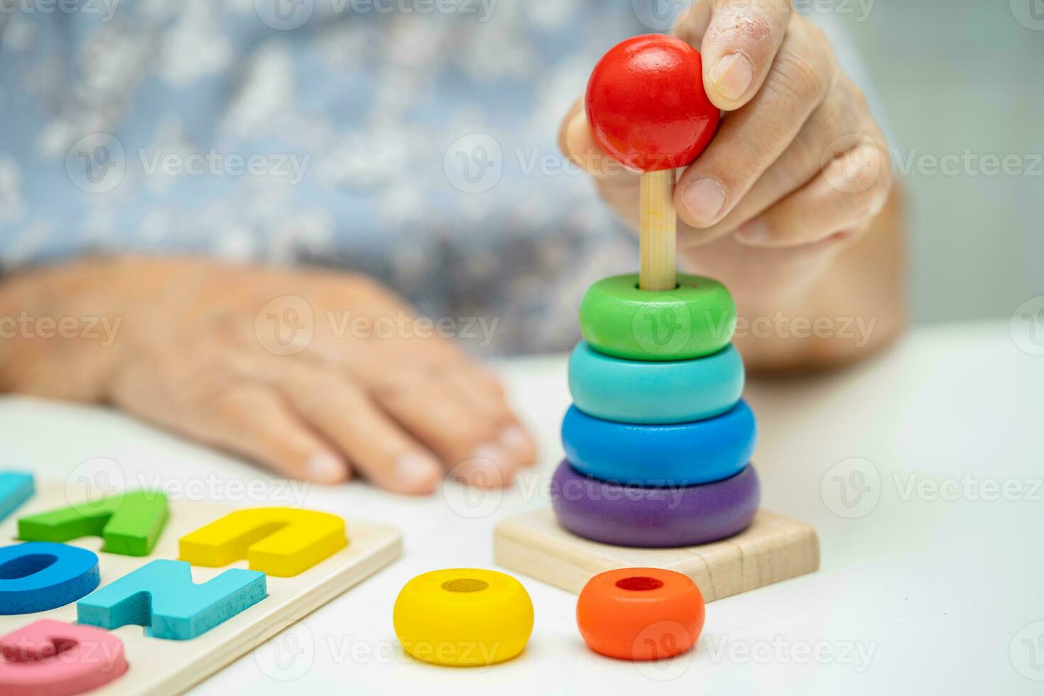 Alzheimer disease AD, Asian elderly woman patient suffering from dementia learn practical motor skills rehabilitation. photo