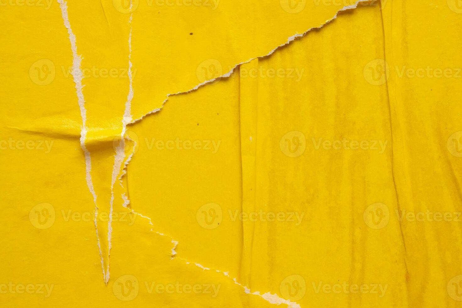 Old grunge ripped torn yellow paper poster surface texture background photo