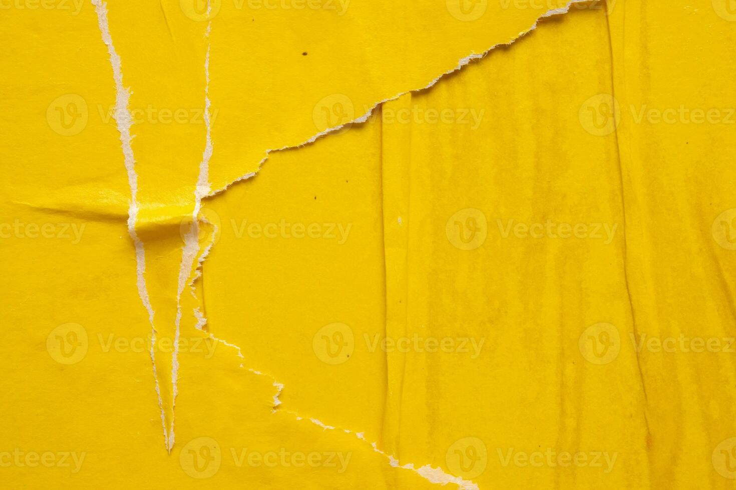 Old grunge ripped torn yellow paper poster surface texture background photo