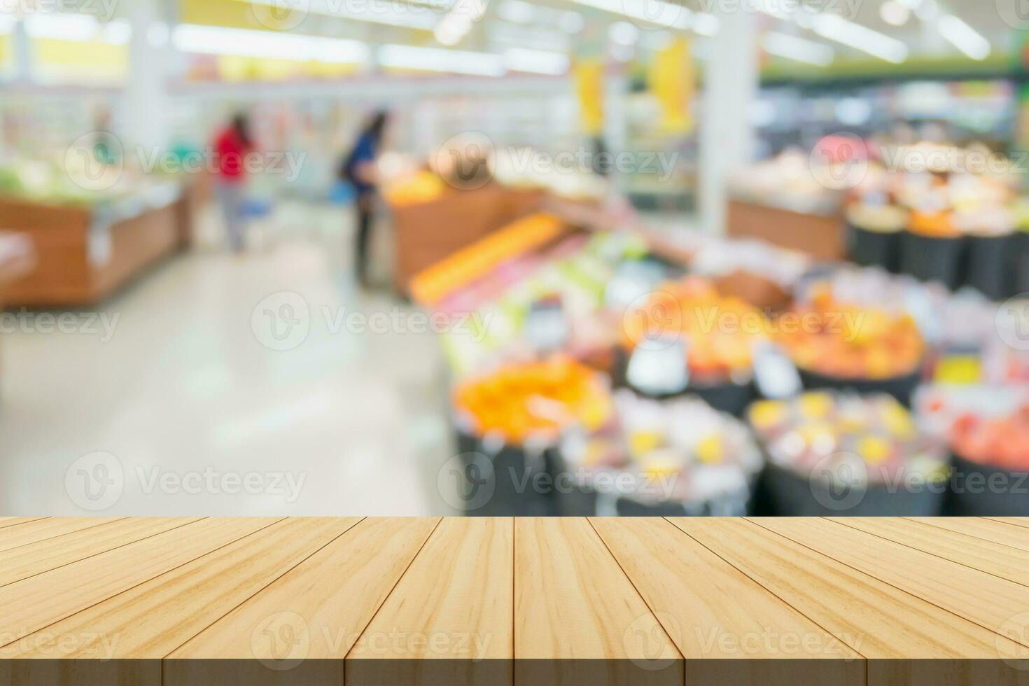 Empty wood table top with supermarket blurred background for product display photo