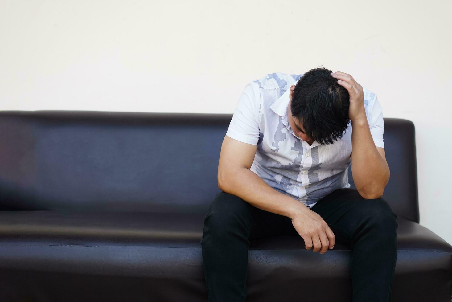 Asian man feels sad, stressed, depressed, hand covered his head. Concept, drepression, failure, disappointment, broken heart. guilty, have life problems. Major Depressive Disorder photo