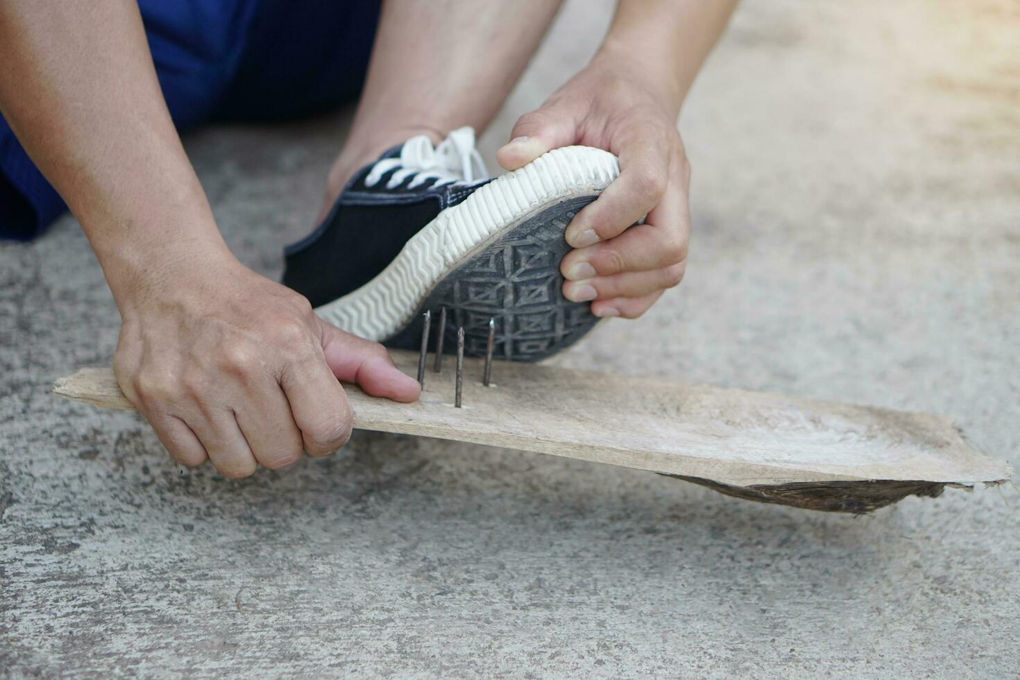 Close up hands are pulling out nails from shoes. Concept, unsafe , risk for dangerous tetanus. Be careful and look around during walking  on the floor or risk places. Accident photo