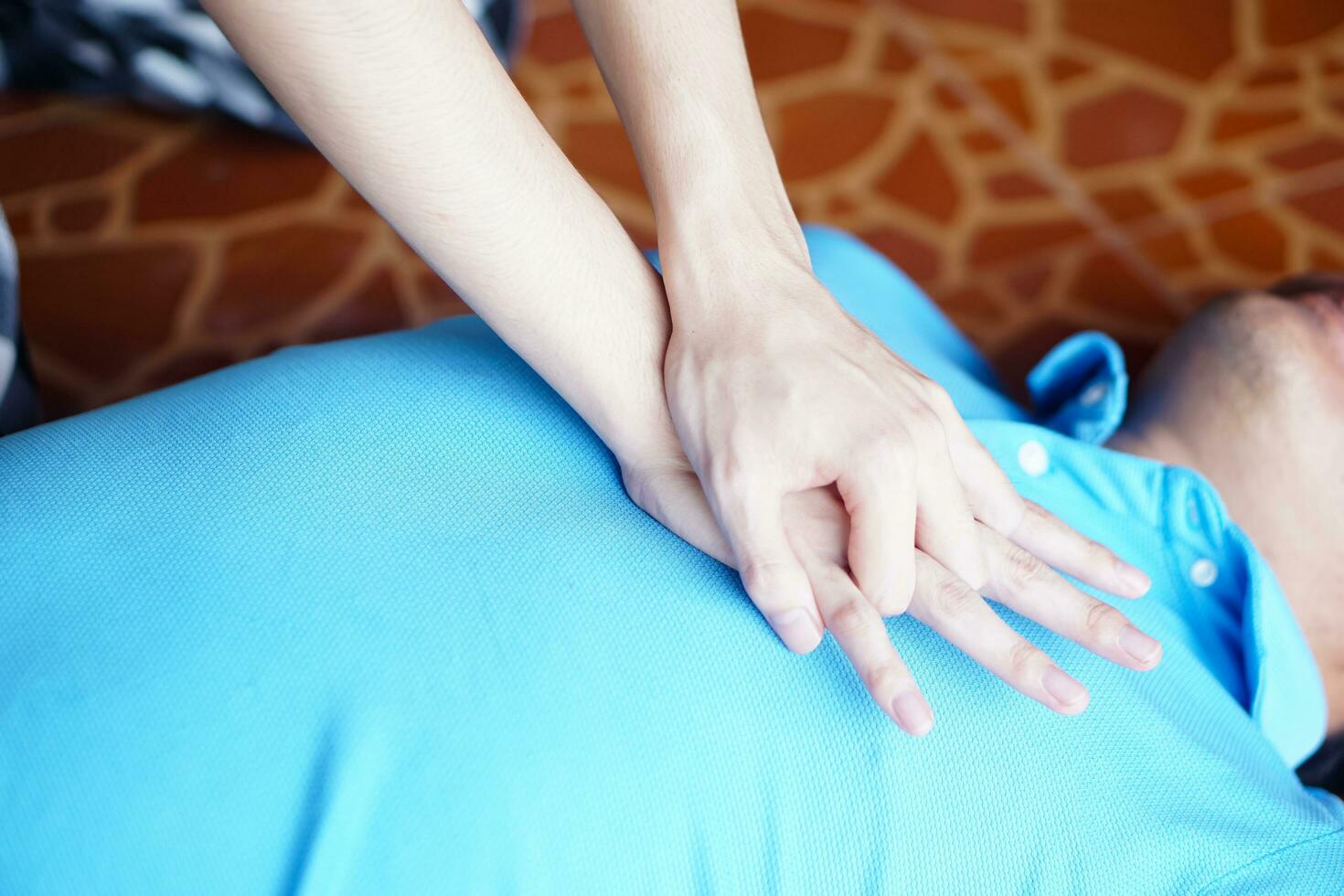 Close up hands  pump on chest for first aid emergency CPR of unconscious man. Concept, Heath care, life rescuse. CPR Cardiopulmonary Resuscitation. Heart pumping for unconscious person. photo