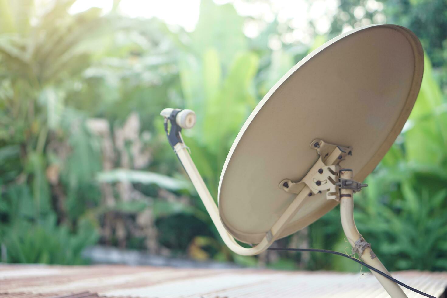 Vintage satellite receiver antenna dish installed on roof. Concept, technology for communication, global broadcast for digital reception through TV. Terrestrial TV receivers. TV antenna device. photo