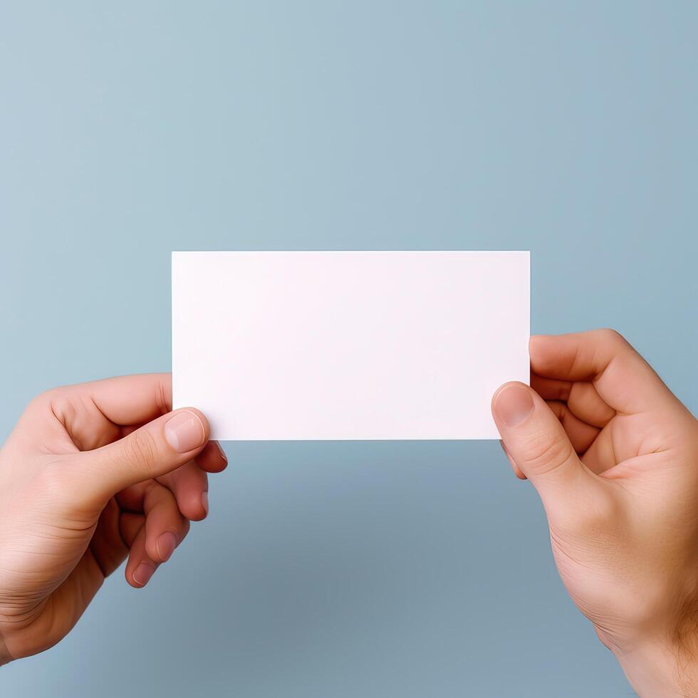 a person holding a blank business card in his hands photo