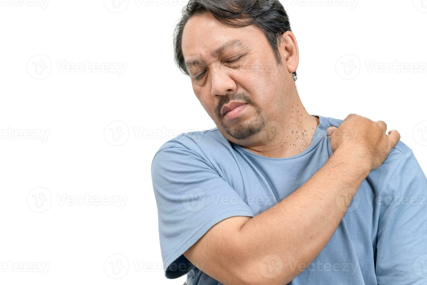 Middle aged man feel neck pain due to working in front of a computer for a long time isolated photo