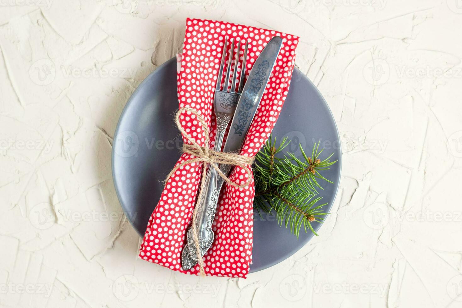 Christmas menu background with fork knife napkin and fir tree brunch on white table. Copy space, top view photo