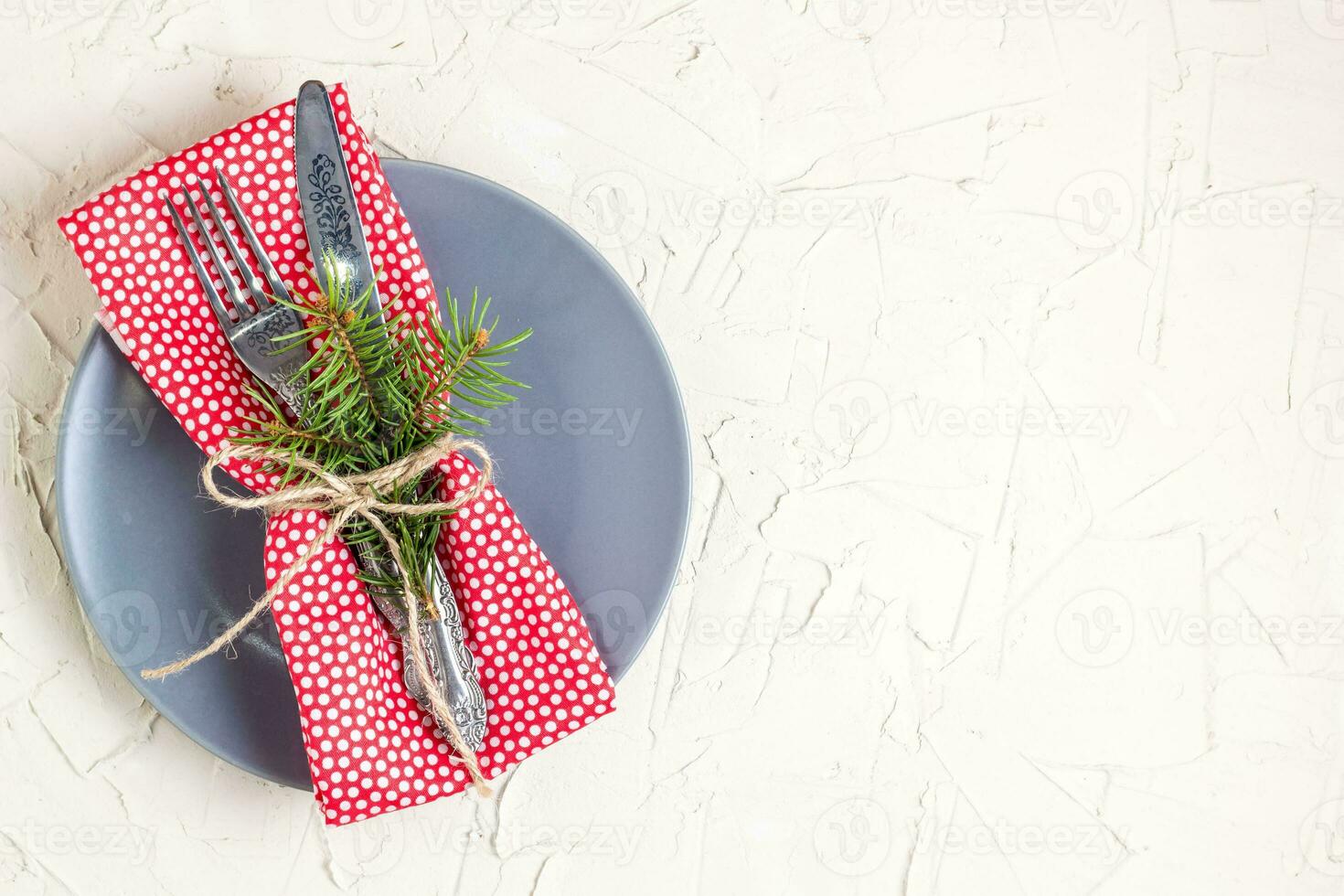 Christmas menu background with fork knife napkin and fir tree brunch on white table. Copy space, top view photo