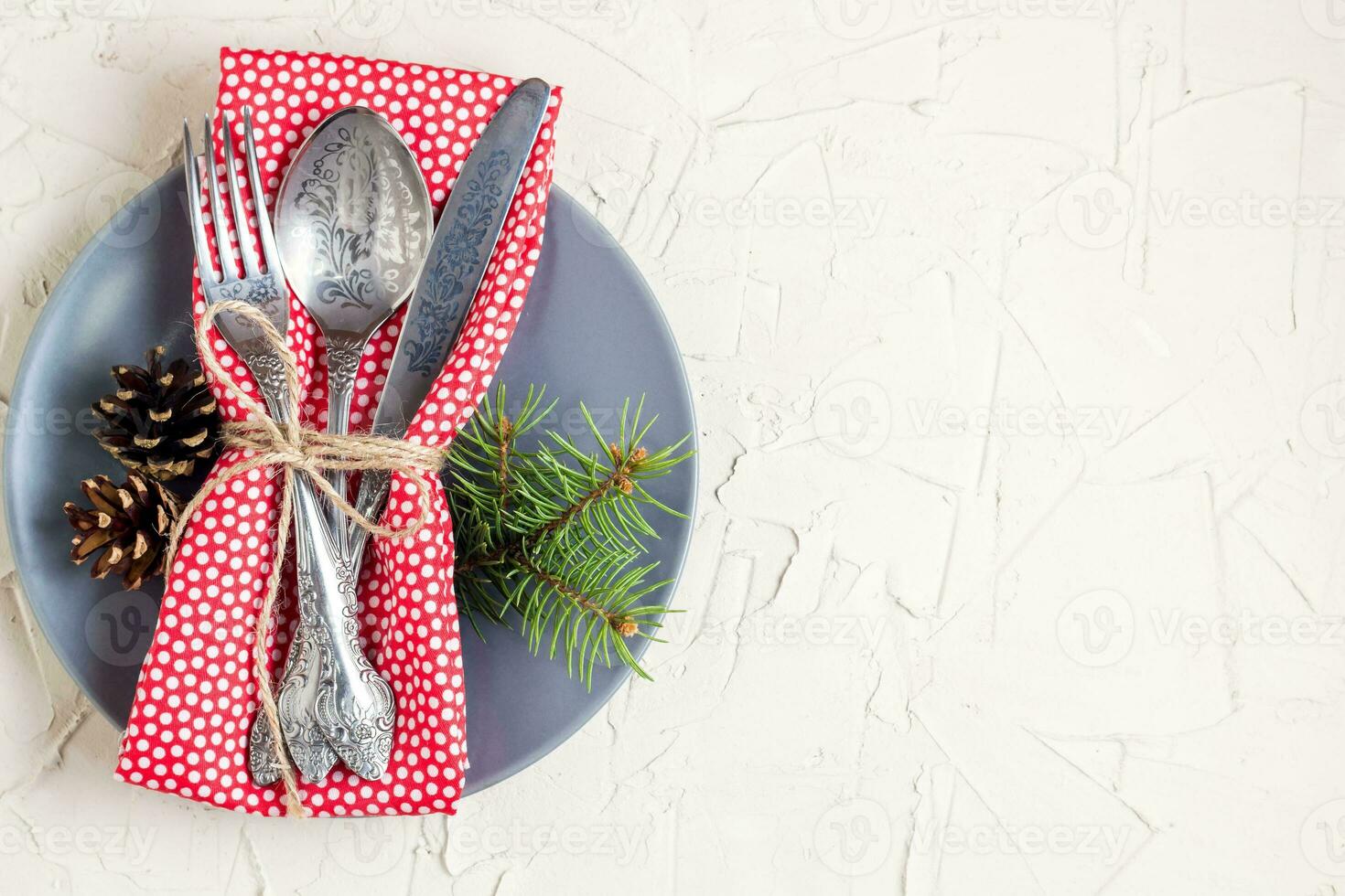 Christmas menu background with fork knife napkin and fir tree brunch on white table. Copy space, top view photo