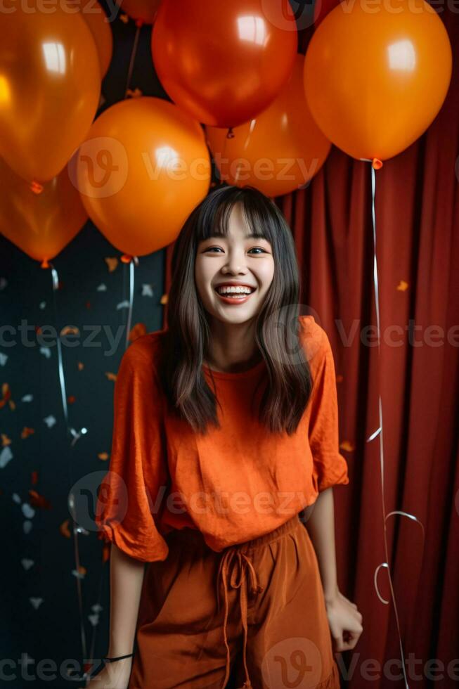 Woman in orange outfit at a party with orange balloons, confetti and curtain in the background. Created with Generative AI technology photo