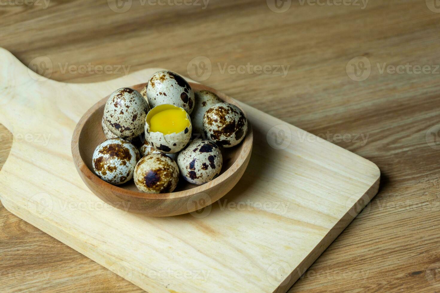quail eggs in wooden bowl. photo