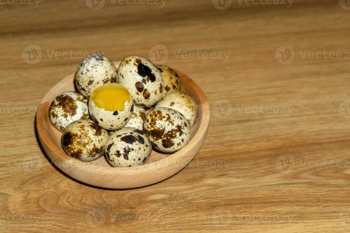 quail eggs in wooden bowl. photo