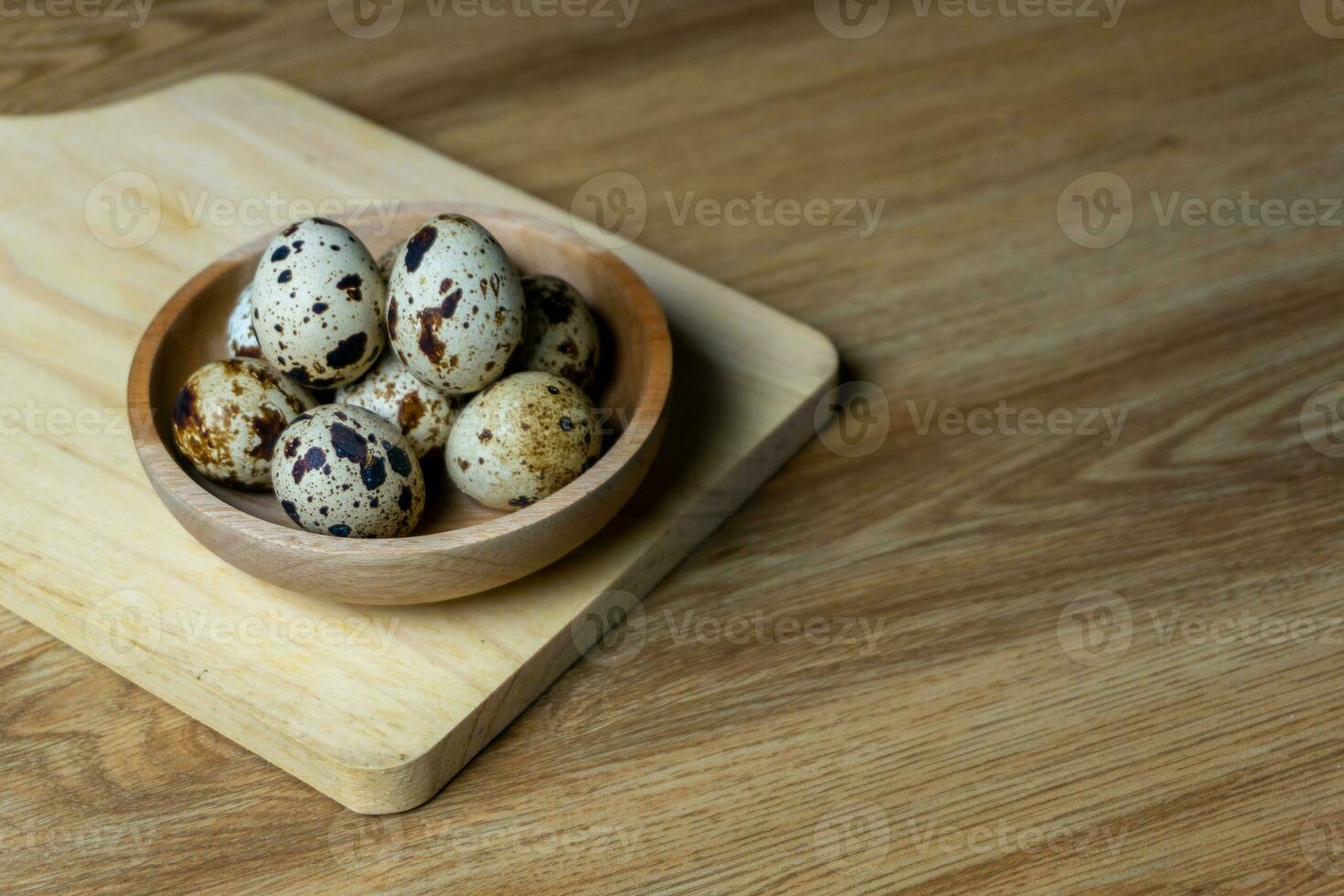 quail eggs in wooden bowl. photo