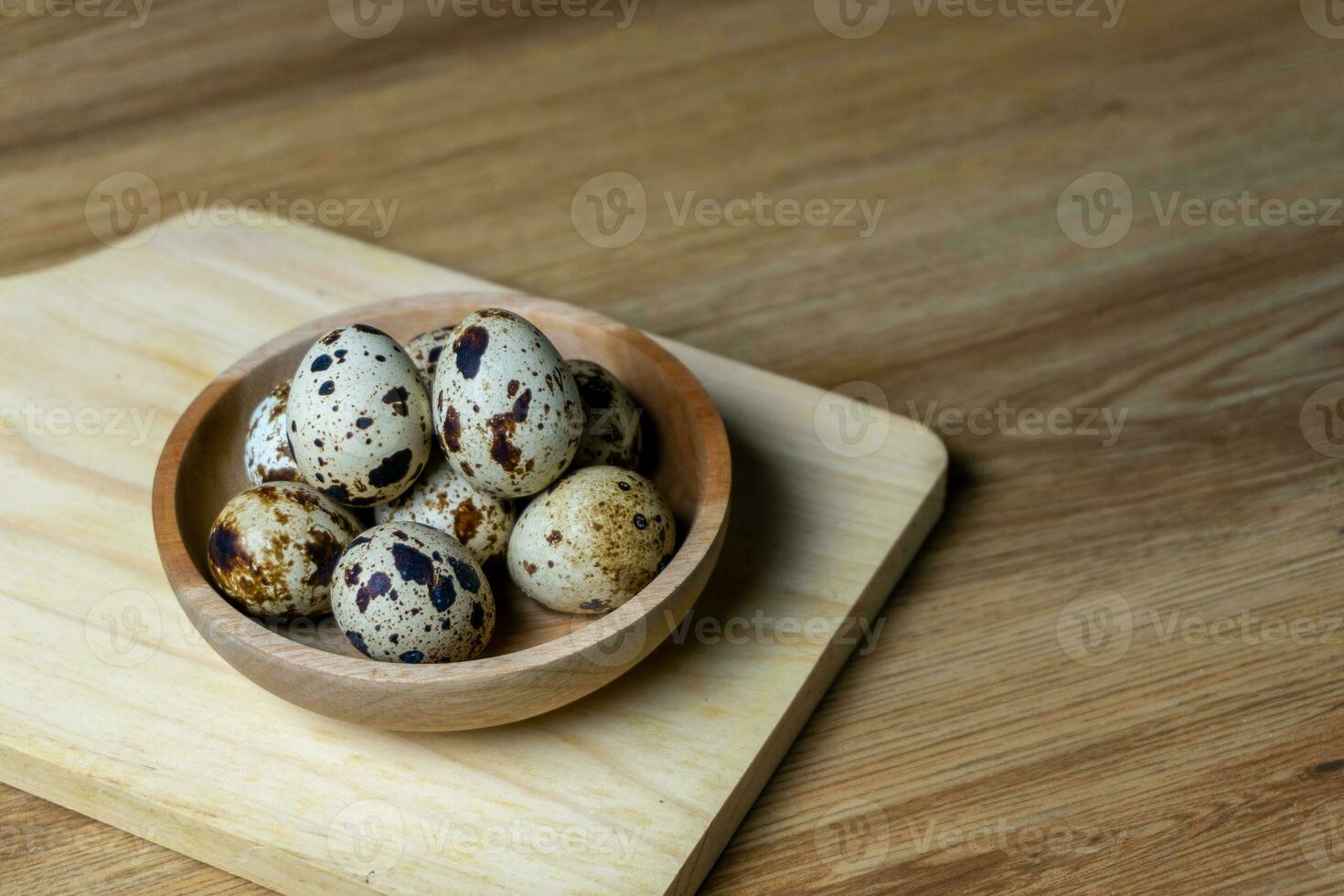 quail eggs in wooden bowl. photo