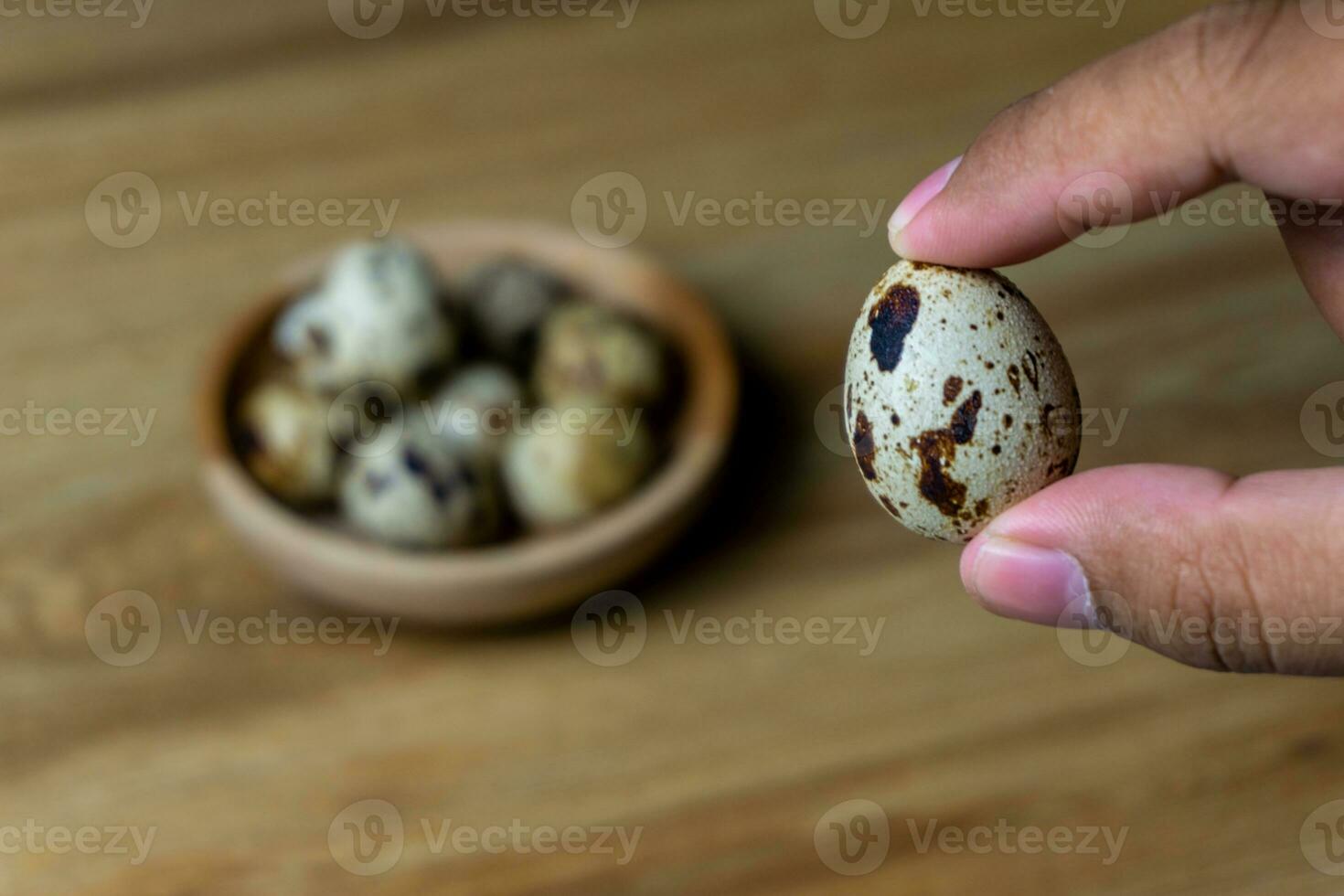 quail eggs in wooden bowl. photo