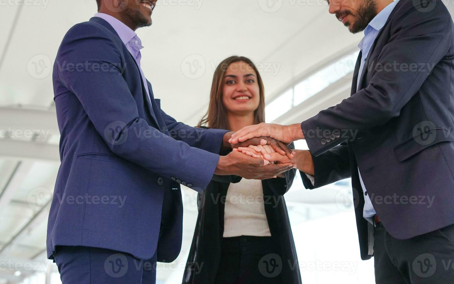 multiracial business people hands stacked for successful business, young happy business teamwork working outside building. selective focus at their hands photo