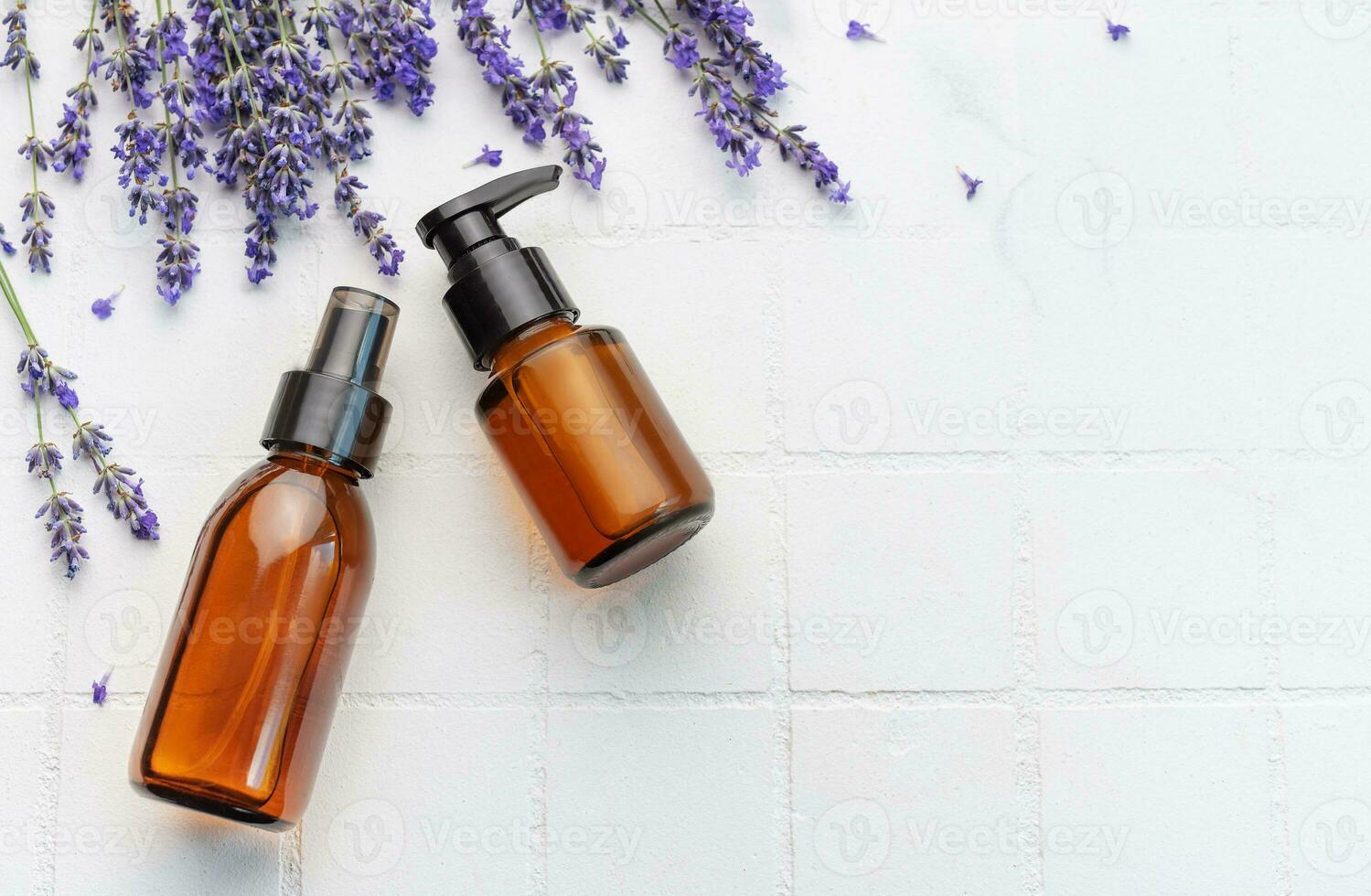 Lavender  natural essential oil and fresh lavender on a white tile background photo
